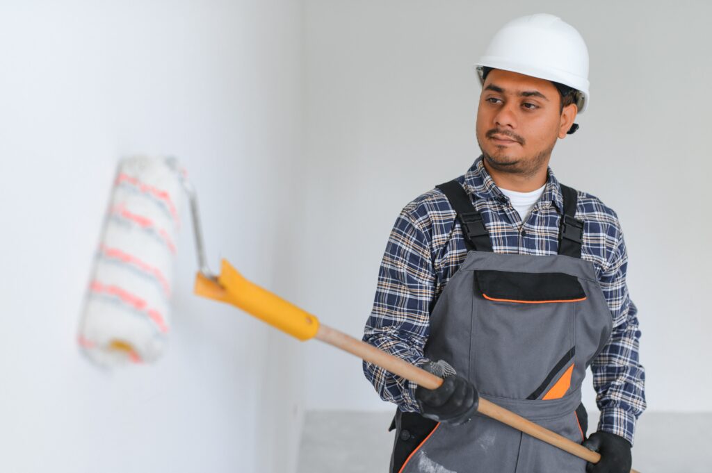 Indian worker makes repairs in an apartment